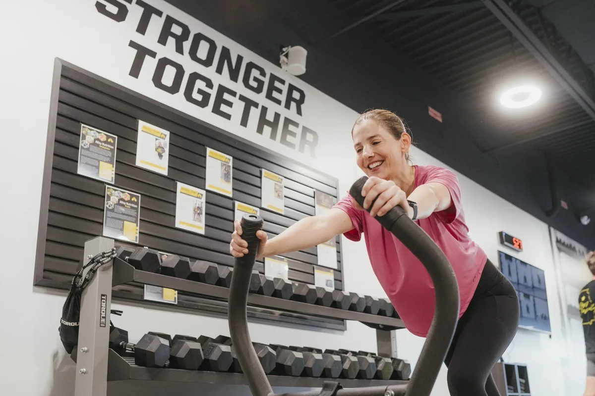 A member pauses between sets at the sled during a session at an Alloy Personal Training studio