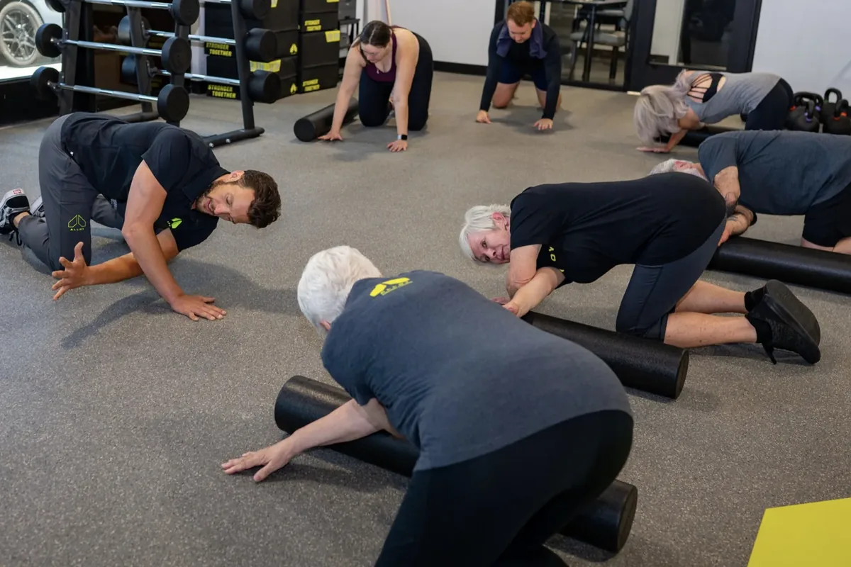 Members wind down with foam rolling at the end of a session at an Alloy Personal Training studio